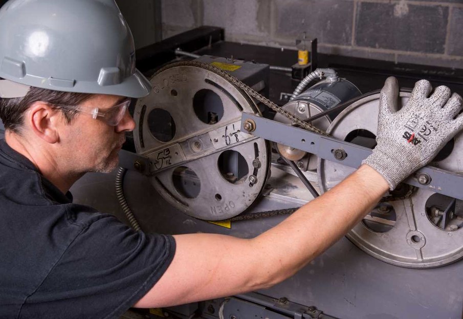 Maintenance Technician repairing elevator equipment