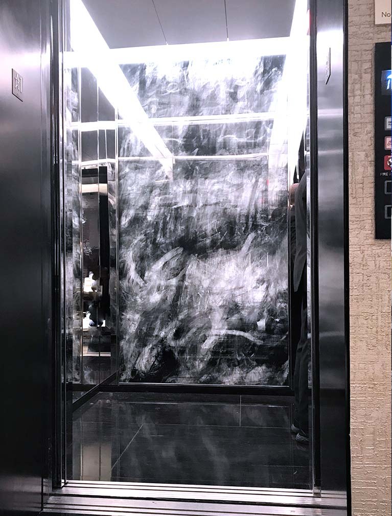 Chanel NYC Headquarters integrated international artwork into their mirrored elevator cab