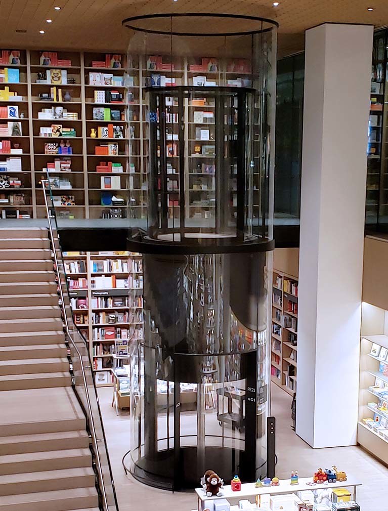 Custom round glass elevator installation at MOMA NYC