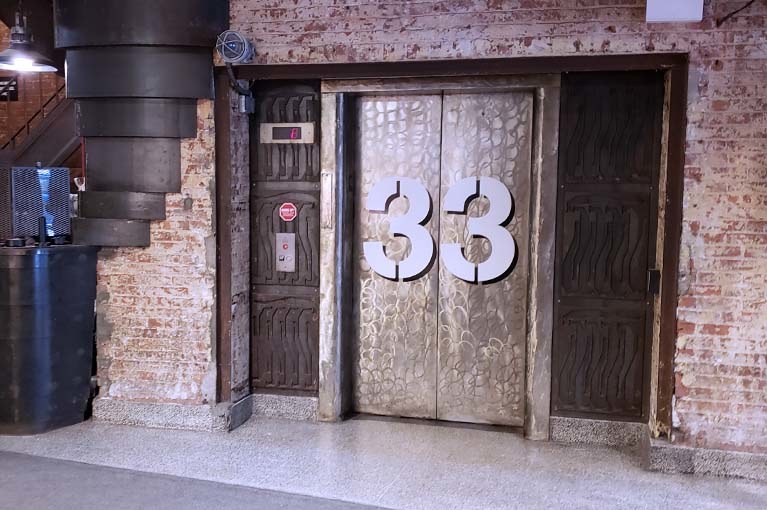 Chelsea Market has carved elevator locations into unique spaces including lift # 33 located adjacent to a spiral staircase at the markets entrance