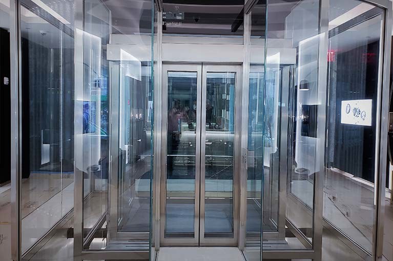 Richard Mille NYC Flagship glass elevator with beveled stainless steel edging and transparent presentation