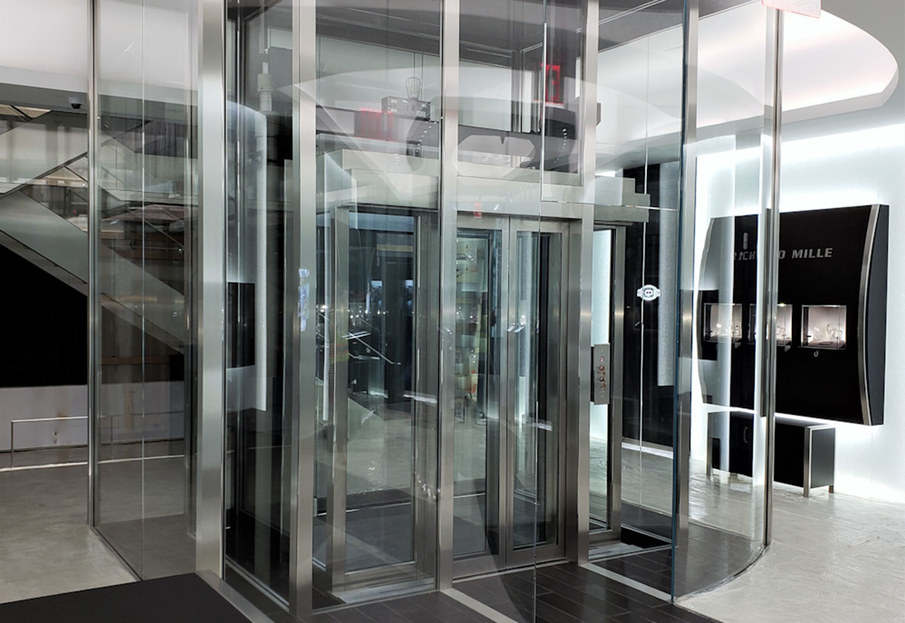Custom glass elevator at Richard Mille, beveled steel and glass